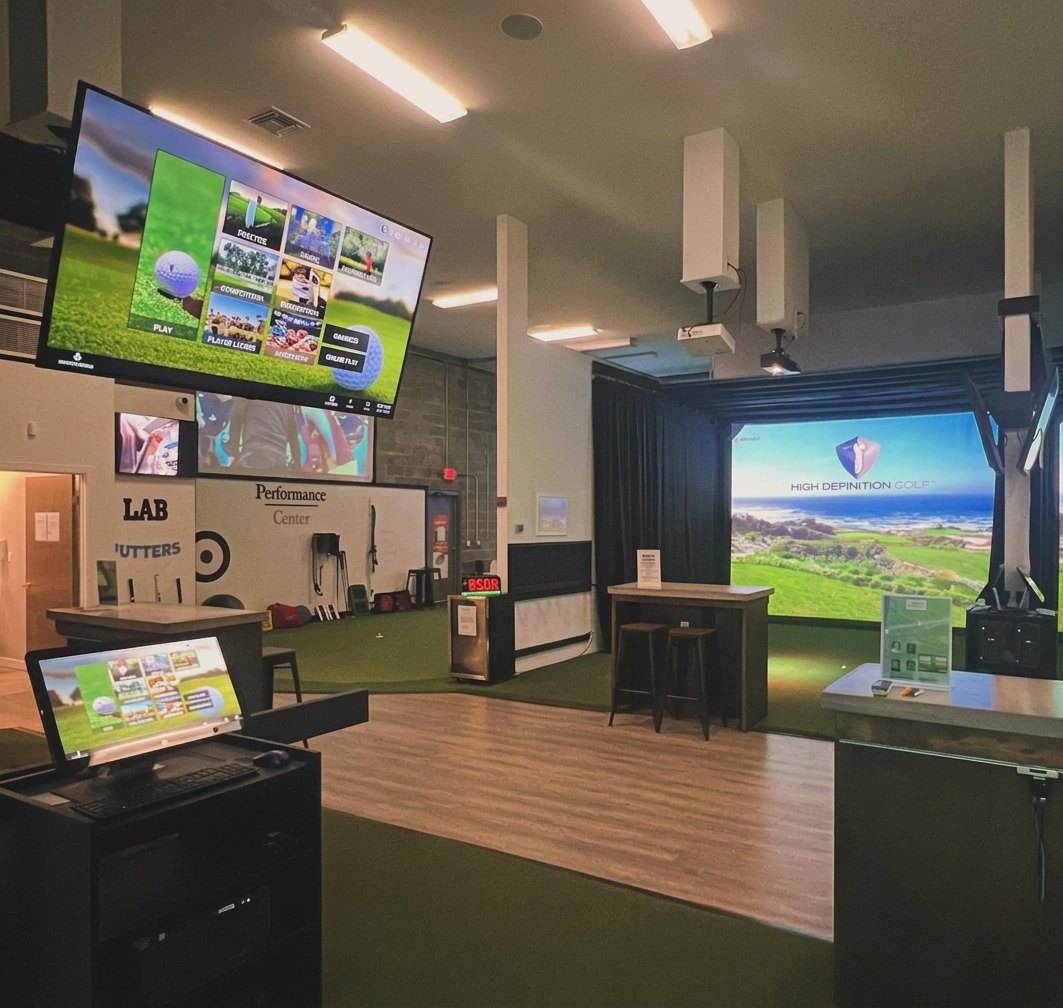 Full Circle Golf main floor with simulator bay and LAB putters display
