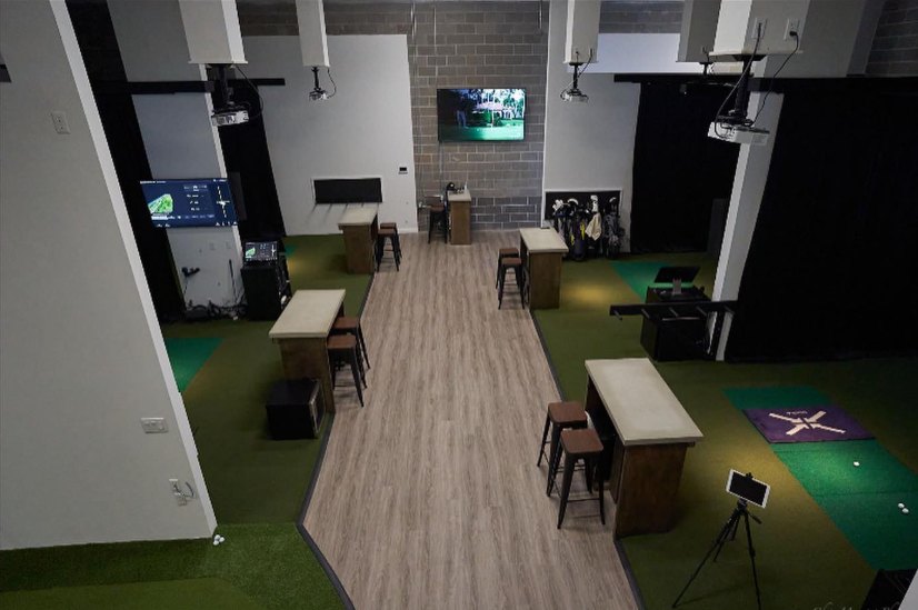 Overhead view of the Full Circle Golf simulator bays and high-top tables